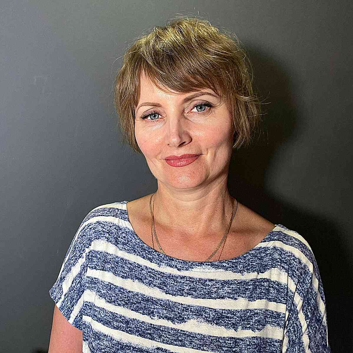 Sweeping Fringe on an Ear-Length Bob with highlights for older women