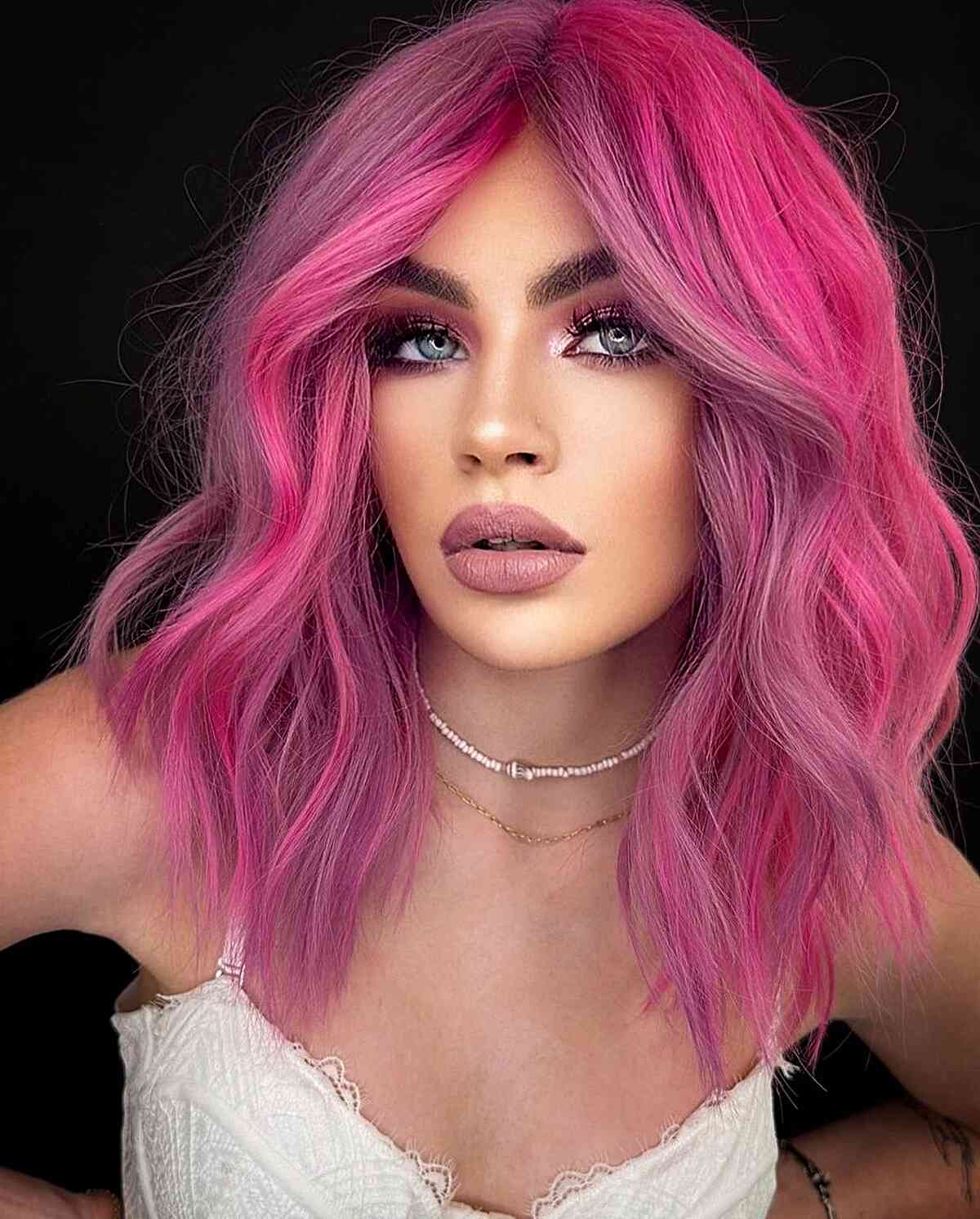 Swoon-Worthy Pink Hair for women with mid-length hair and a middle part
