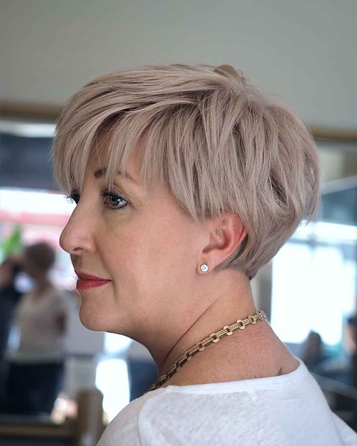 tapered blonde pixie with long bangs