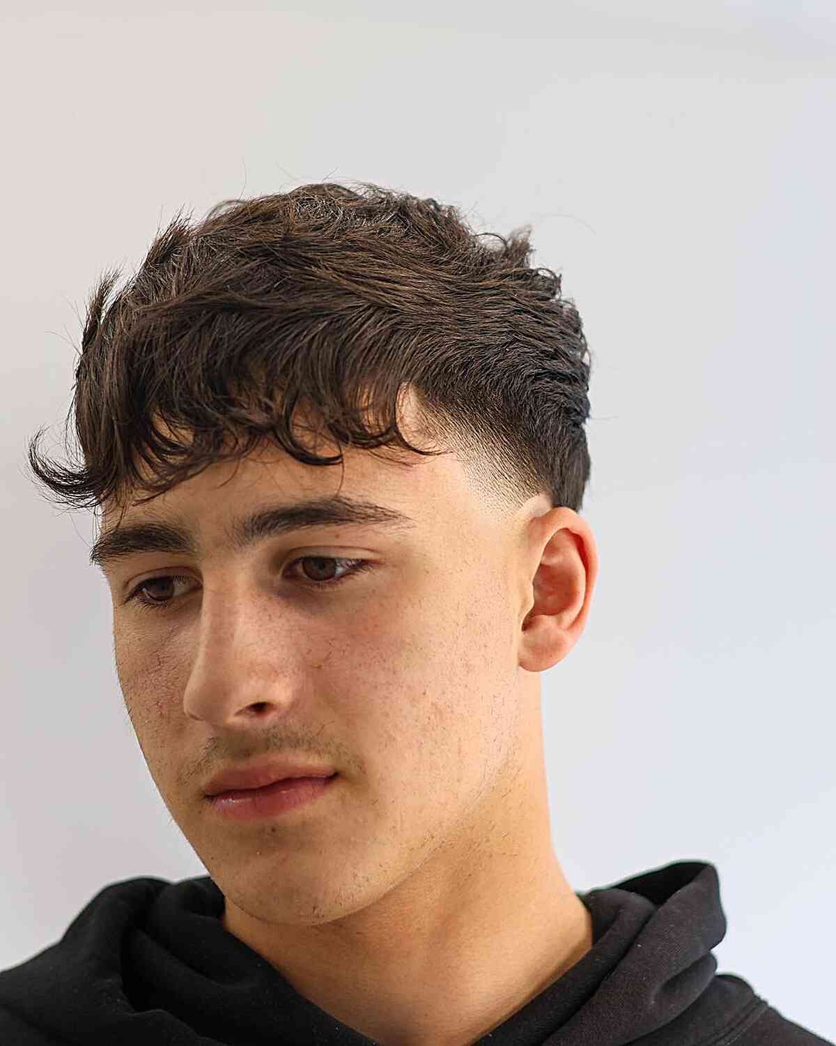 Neat Temple Taper Fade with Textured Bangs for Guys