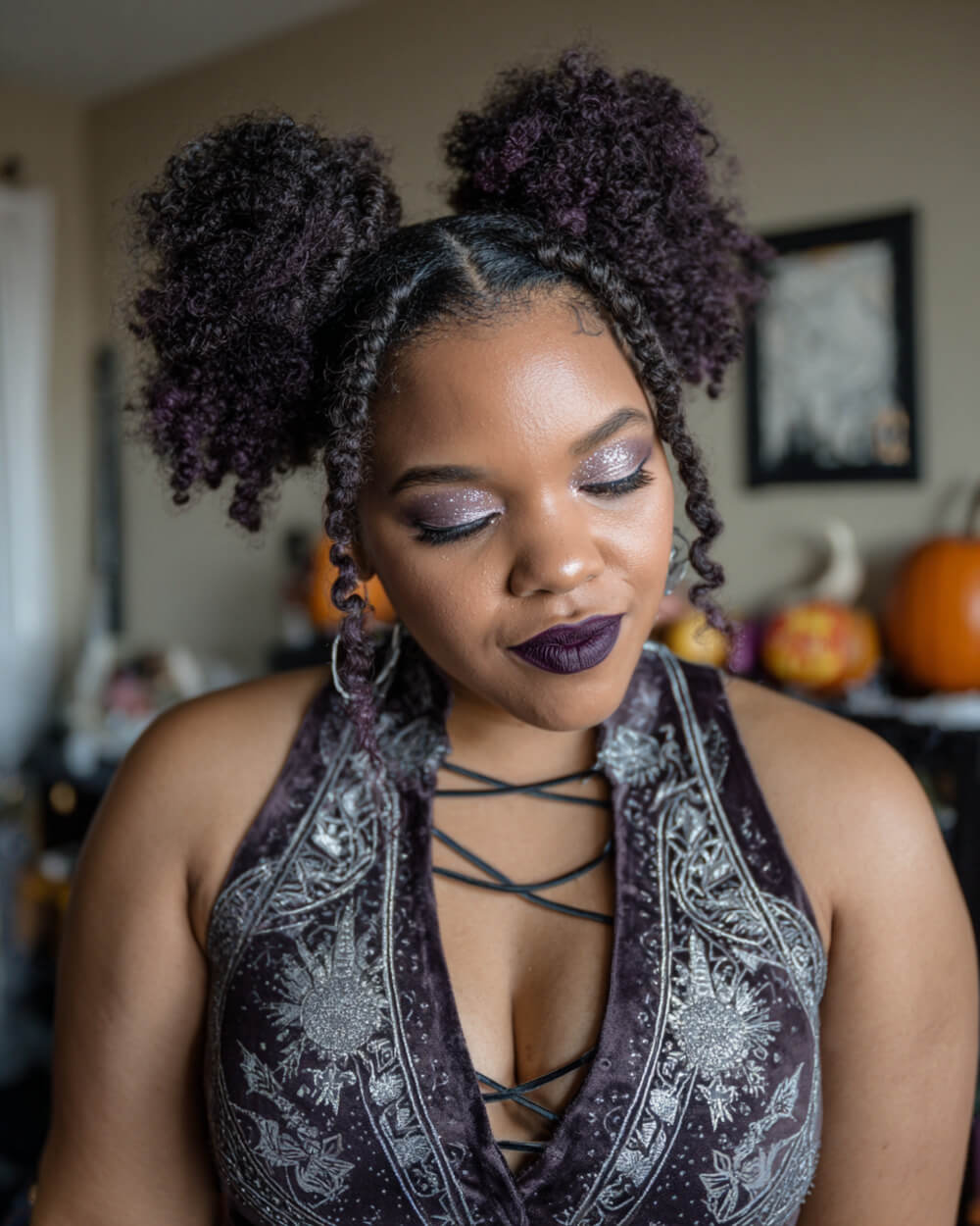 Textured afro puffs with braided middle part, bold Halloween hairstyle.