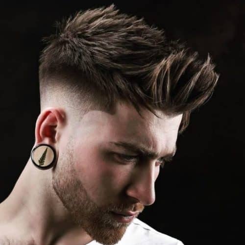 Textured and messy haircut with low skin fade