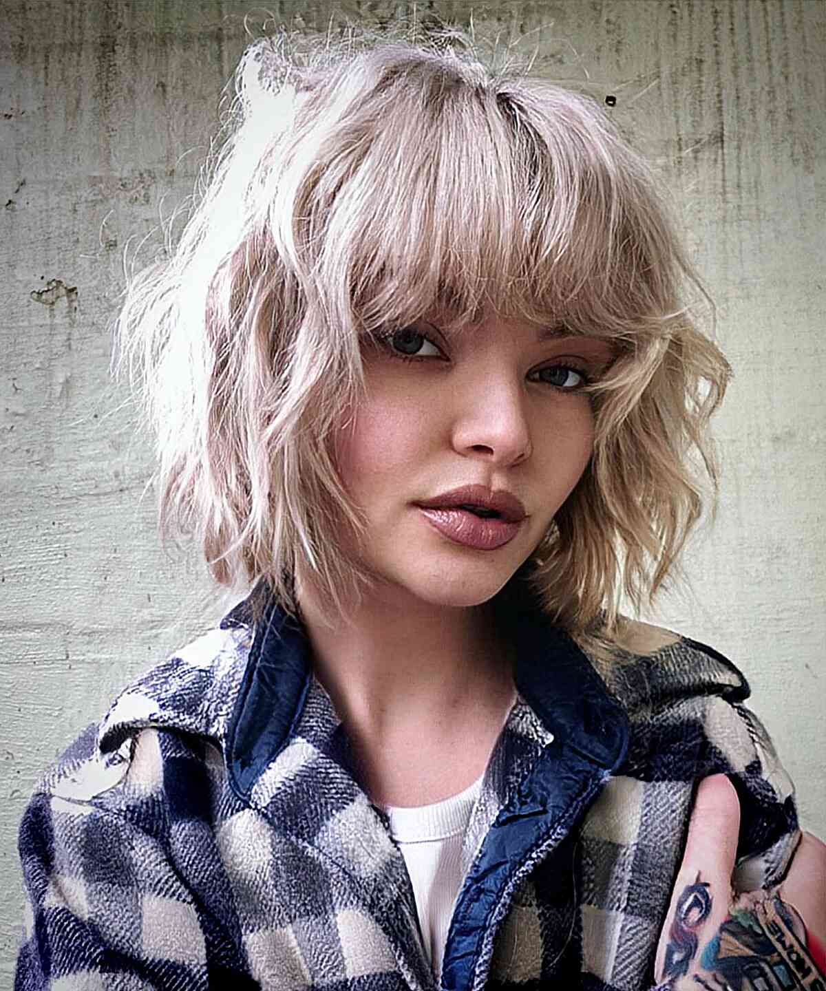Textured and Tousled Platinum Bob with Bangs for girls with a messy style