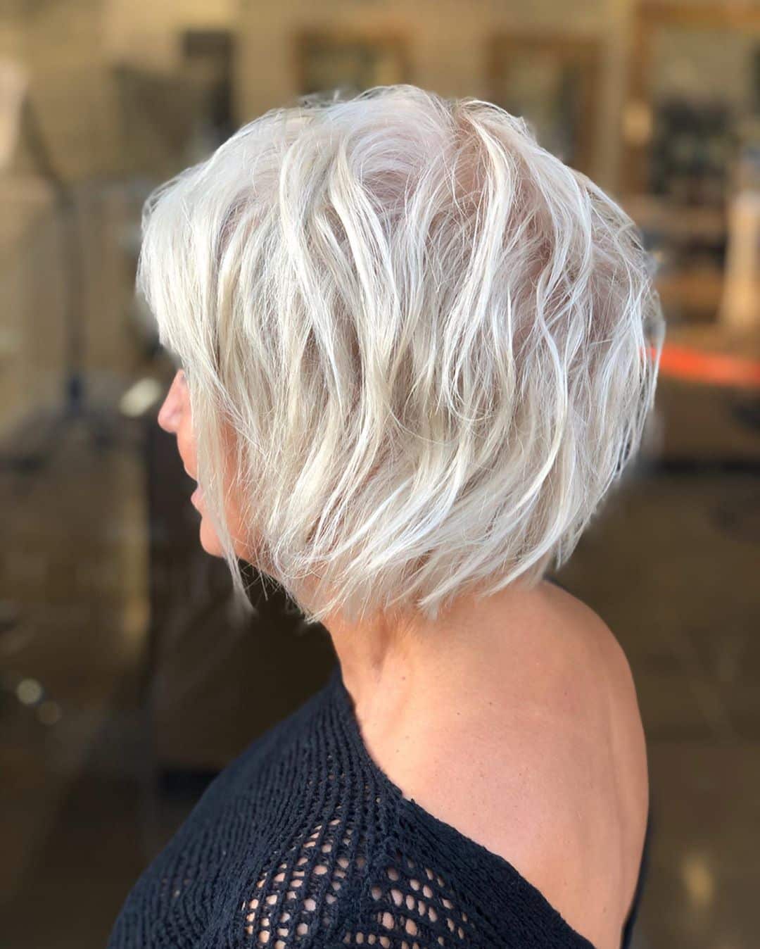textured bob hairstyle for women over 50 with silver hair
