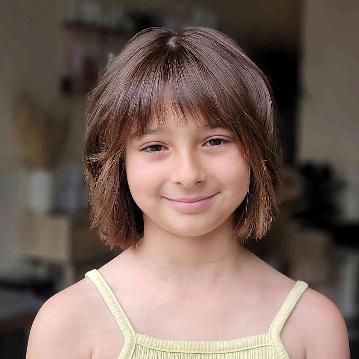Textured haircut with bangs for little girls with straight hair