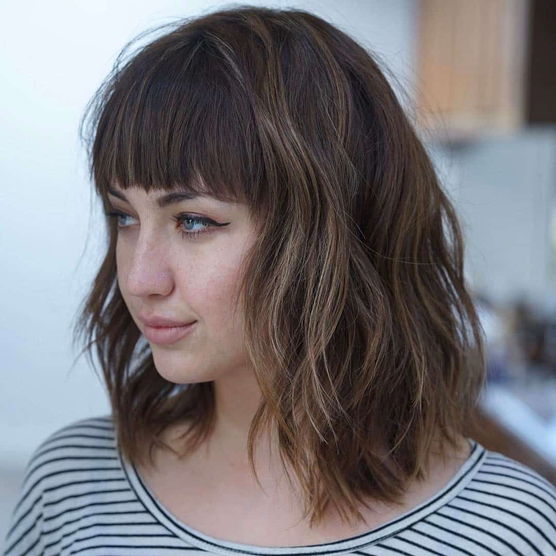 Versatile Textured Lob with Bangs and Loose Waves for Round Face Shape