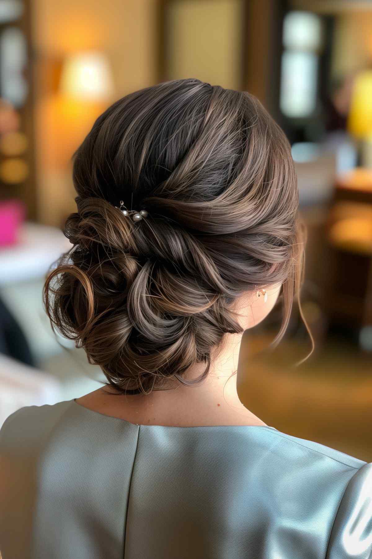 Textured low bun with soft twists and pearls for fine hair