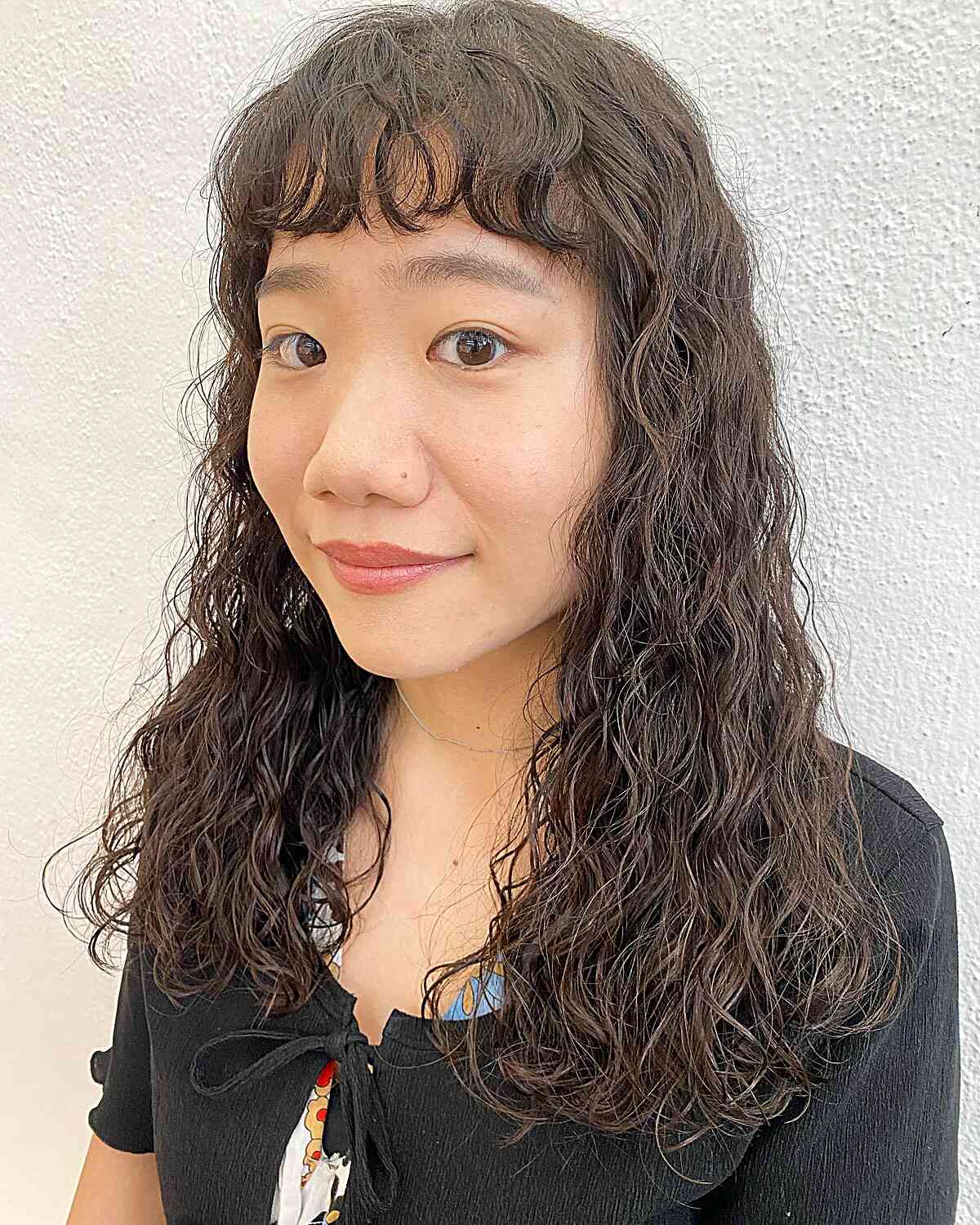 Chest-Length Textured Messy Body Perm Waves with Bangs