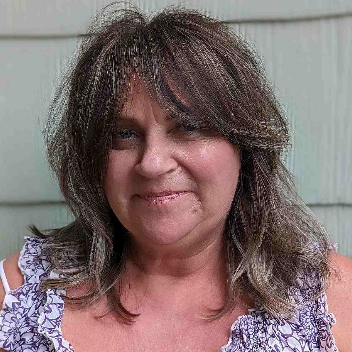 Textured Mid-Length Hair with Long Curtain Bangs for Women Past 60