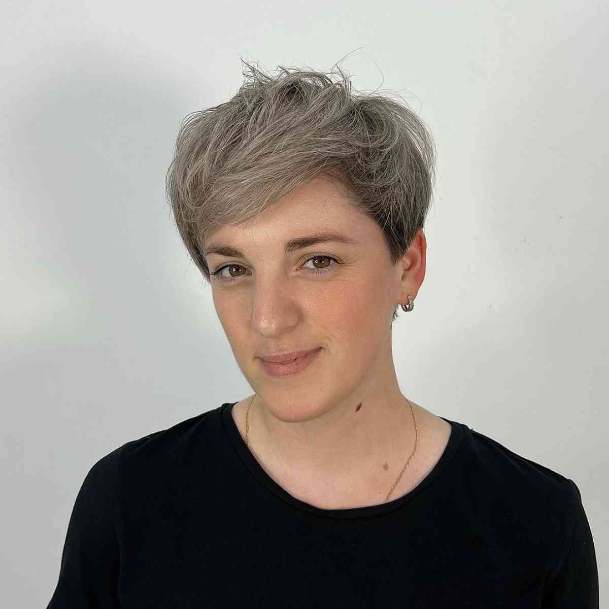 Textured pixie cut with tousled layers and ash blonde highlights on fine hair