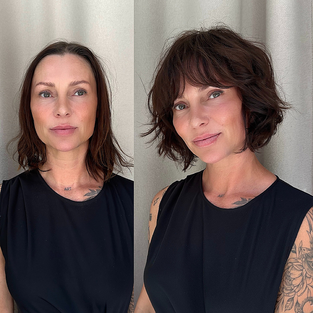Textured shaggy bob with wispy bangs on medium-thick wavy hair, styled for volume and movement with soft face-framing layers