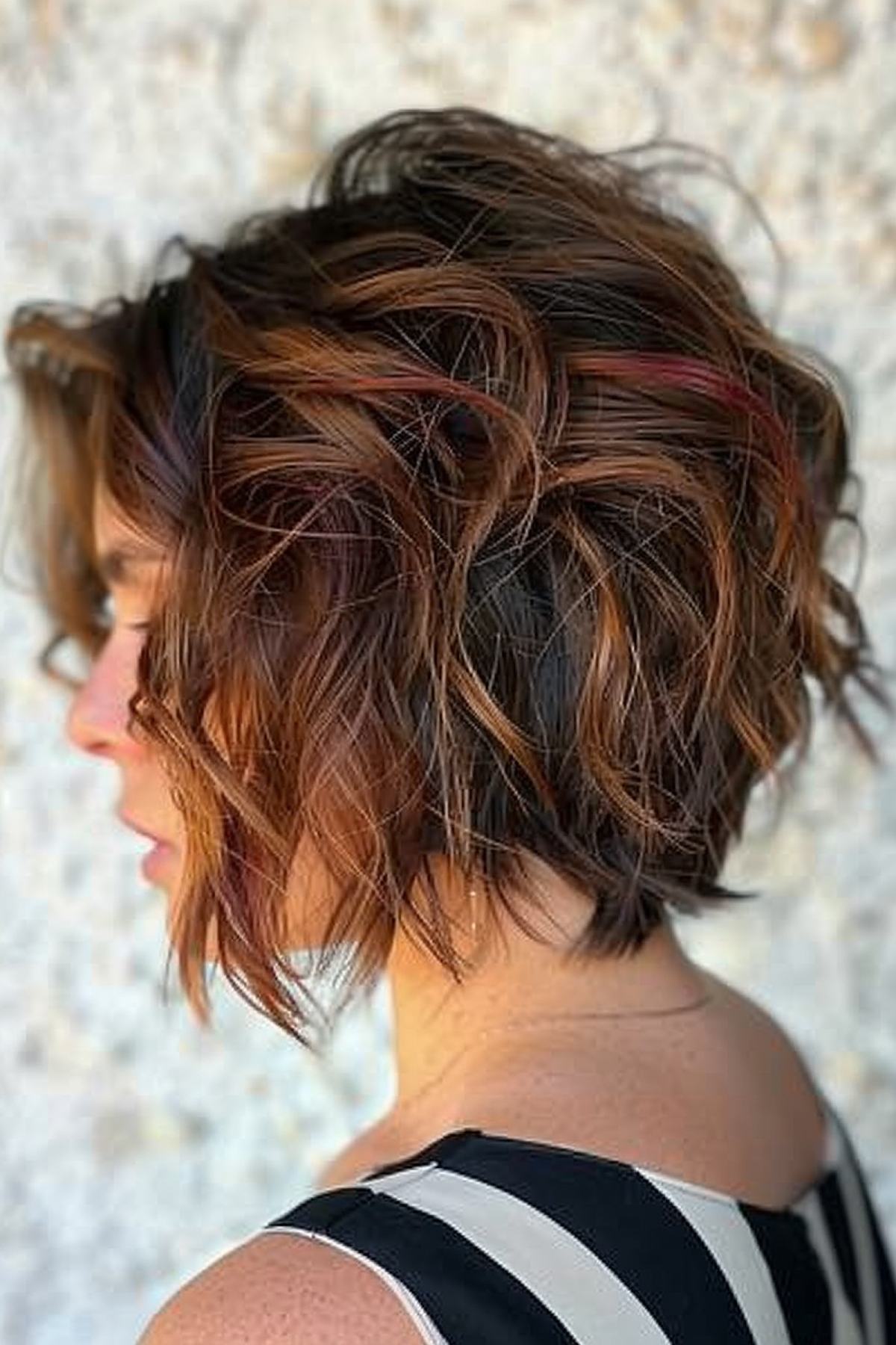 Short stacked bob with red highlights and textured layers
