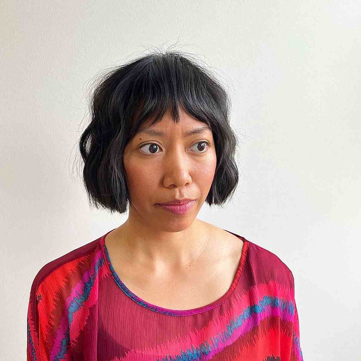 Textured Wavy Chin-Length Bob Cut with a Fringe