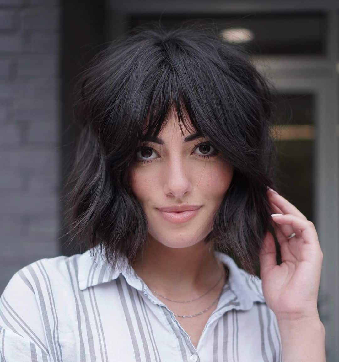 Play with the chin-length shag cut by pairing it with middle-parted bangs. A hairstyle like this requires a specific density of hair. For beauties with thick tresses, this is perfect! When styling, jazz it up with soft waves. That's how you achieve effortless beauty.
