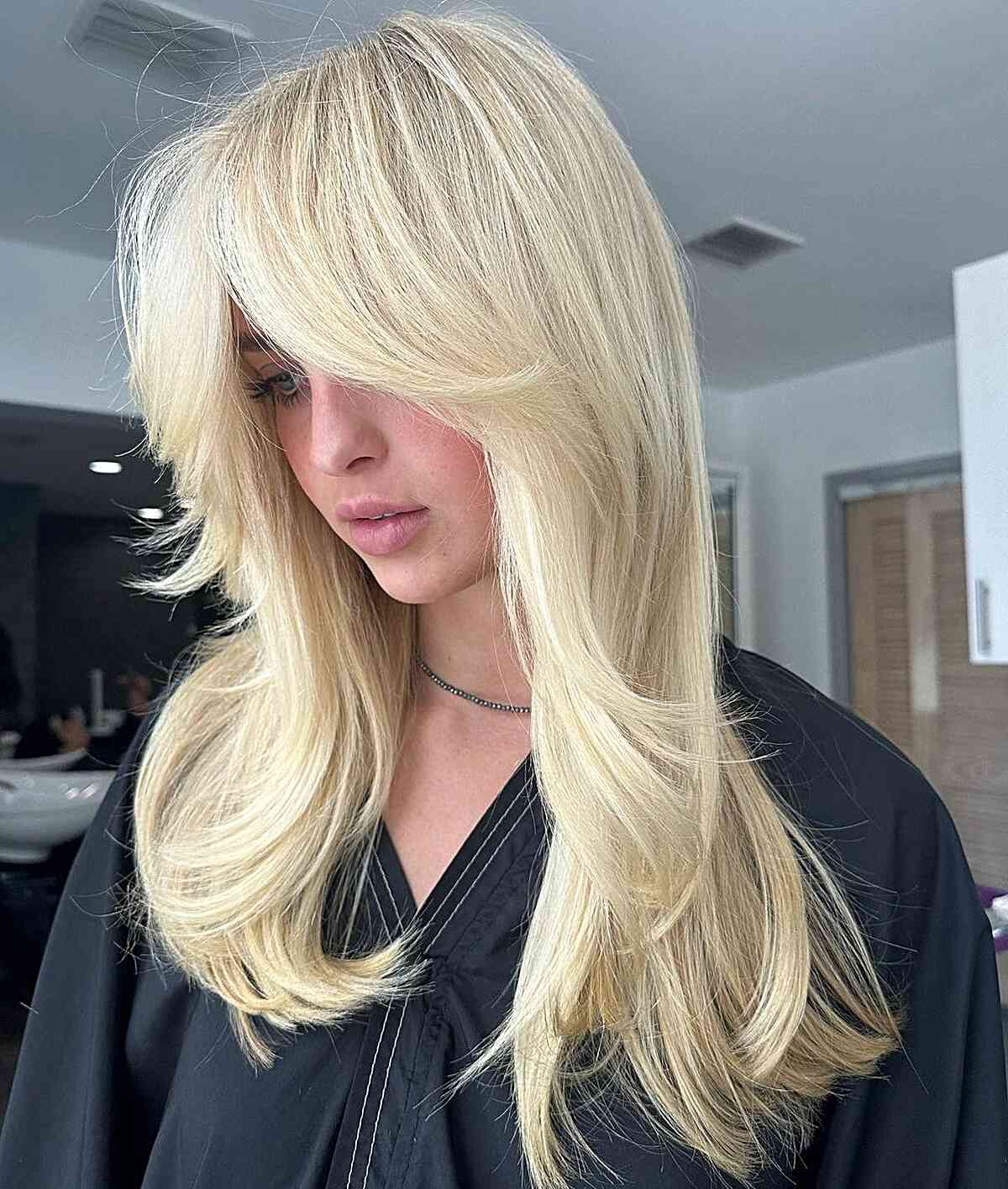 The Perfect Summer Light Blonde Hair Color for women with medium hair and curtain bangs