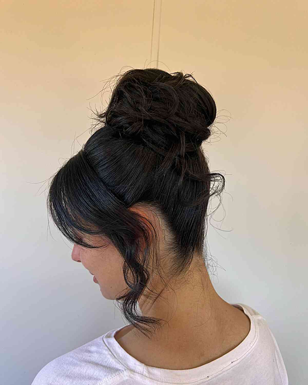 Thick Bun Updo with Face-Framing Bangs and Layers