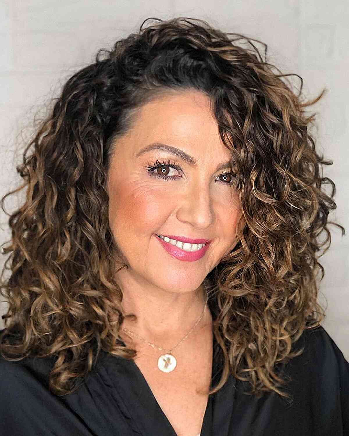 Thick Shoulder-Length Curls with Highlights for Women Aged 40