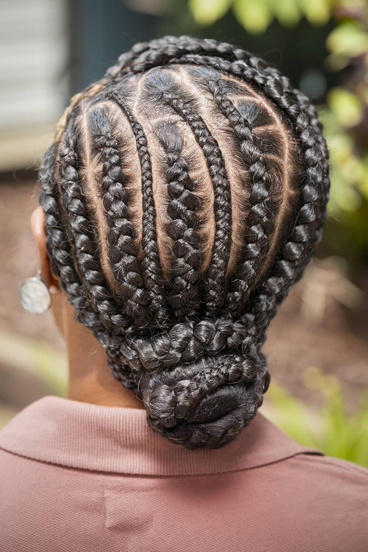 Cornrow hairstyle with a low braided bun for Black women over 60