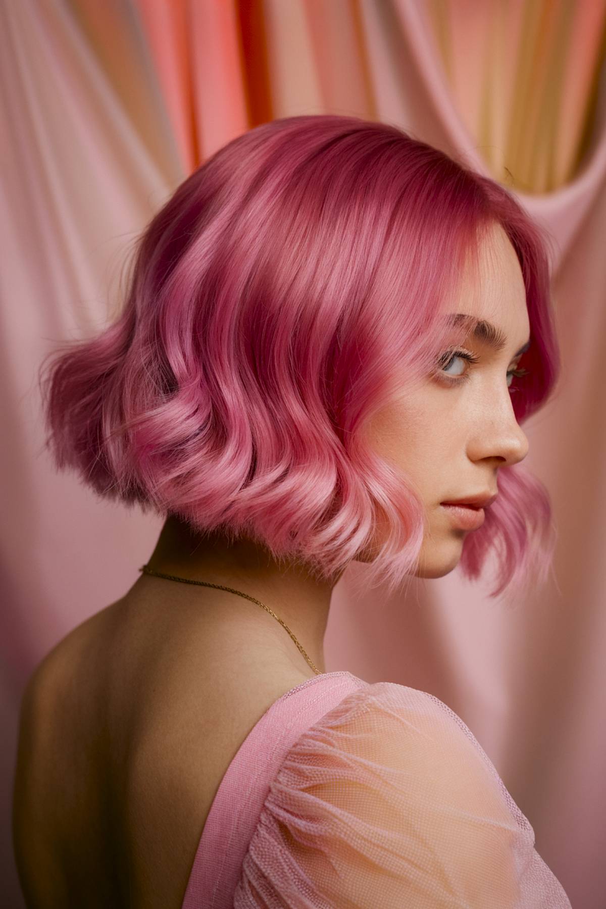 Tourmaline tint bob with soft peach, pink, and coral tones, creating a warm gemstone effect