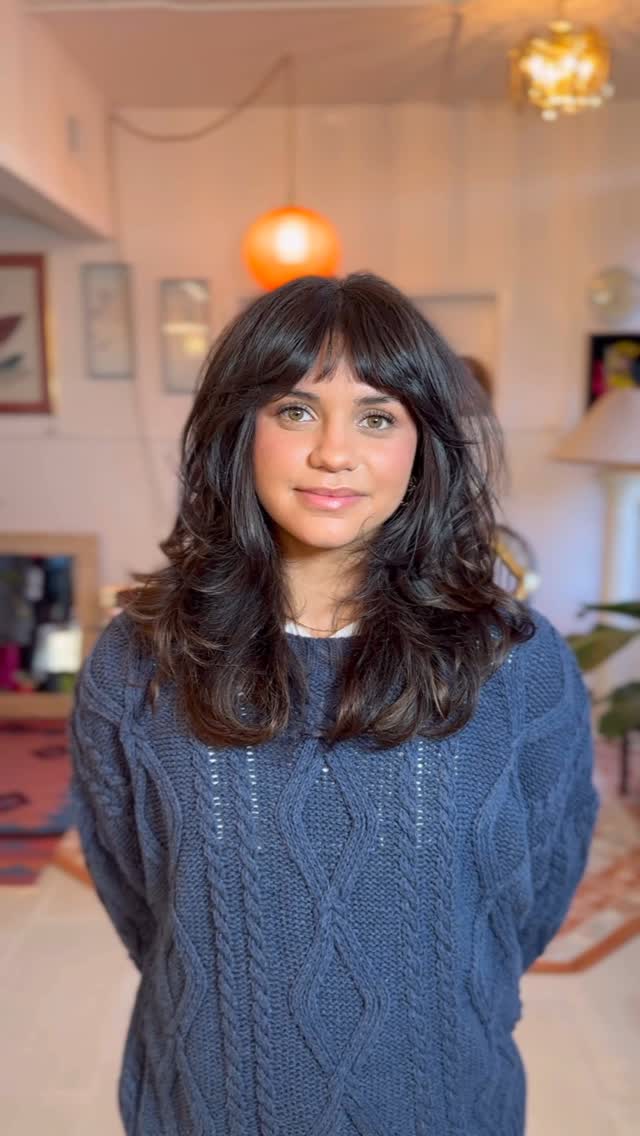 Tousled mid-length haircut with choppy bangs and layered texture for thick hair