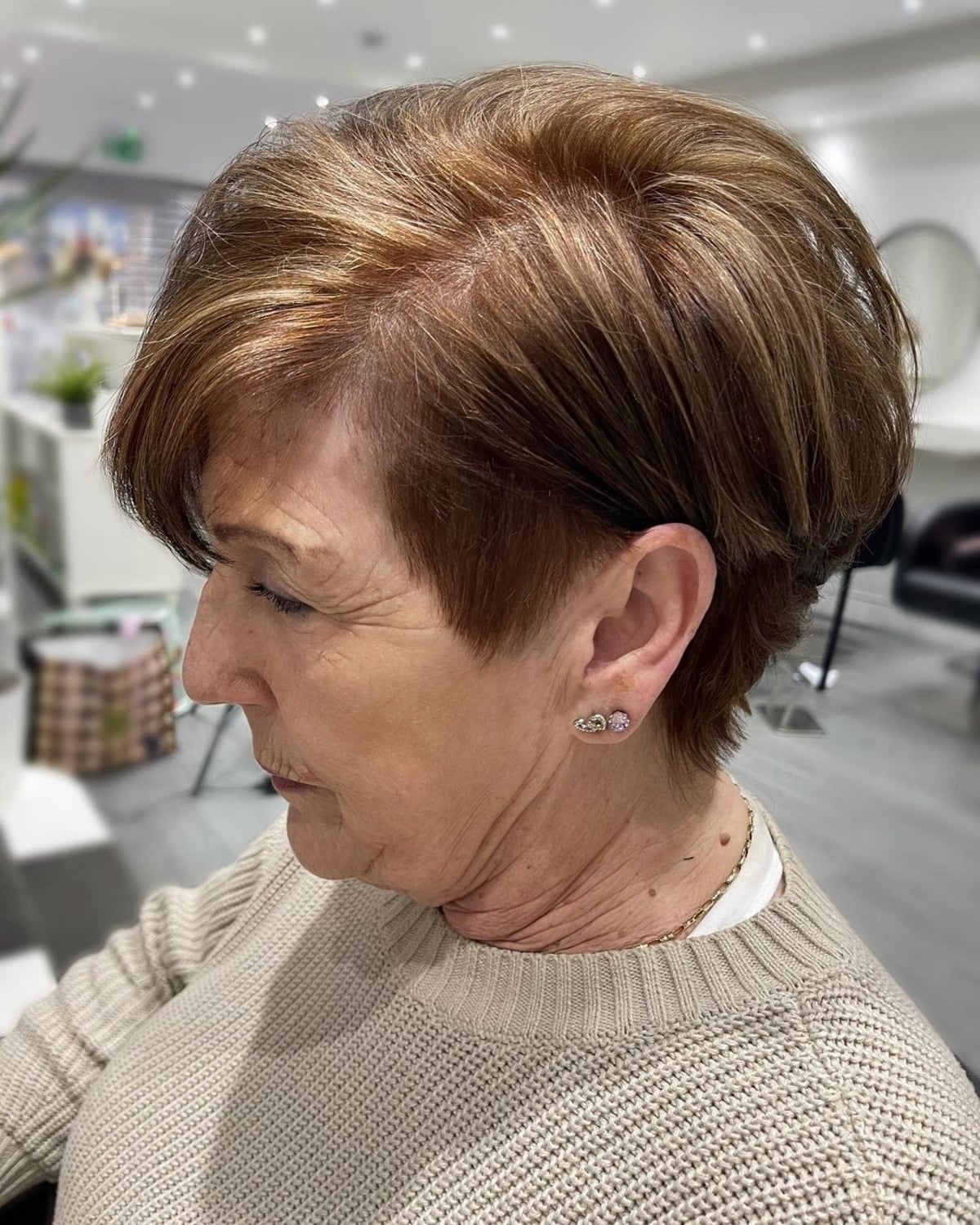 Tousled Pixie Bob with a Shaved Side Style for Older Women