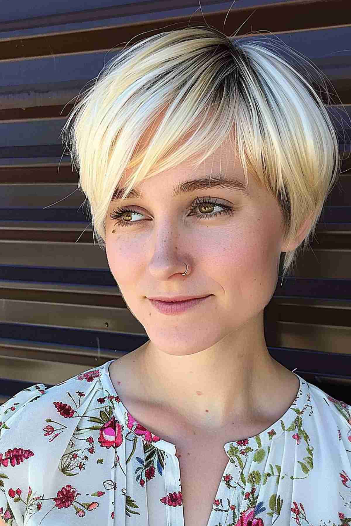 Tousled blonde pixie cut with dynamic highlights for a heart-shaped face, showcasing volume for fine hair