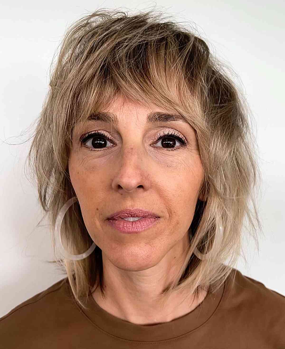 Shoulder-Grazing Tousled Shaggy Long Bob with Bangs for Ladies in Their 50s with Fine Hair