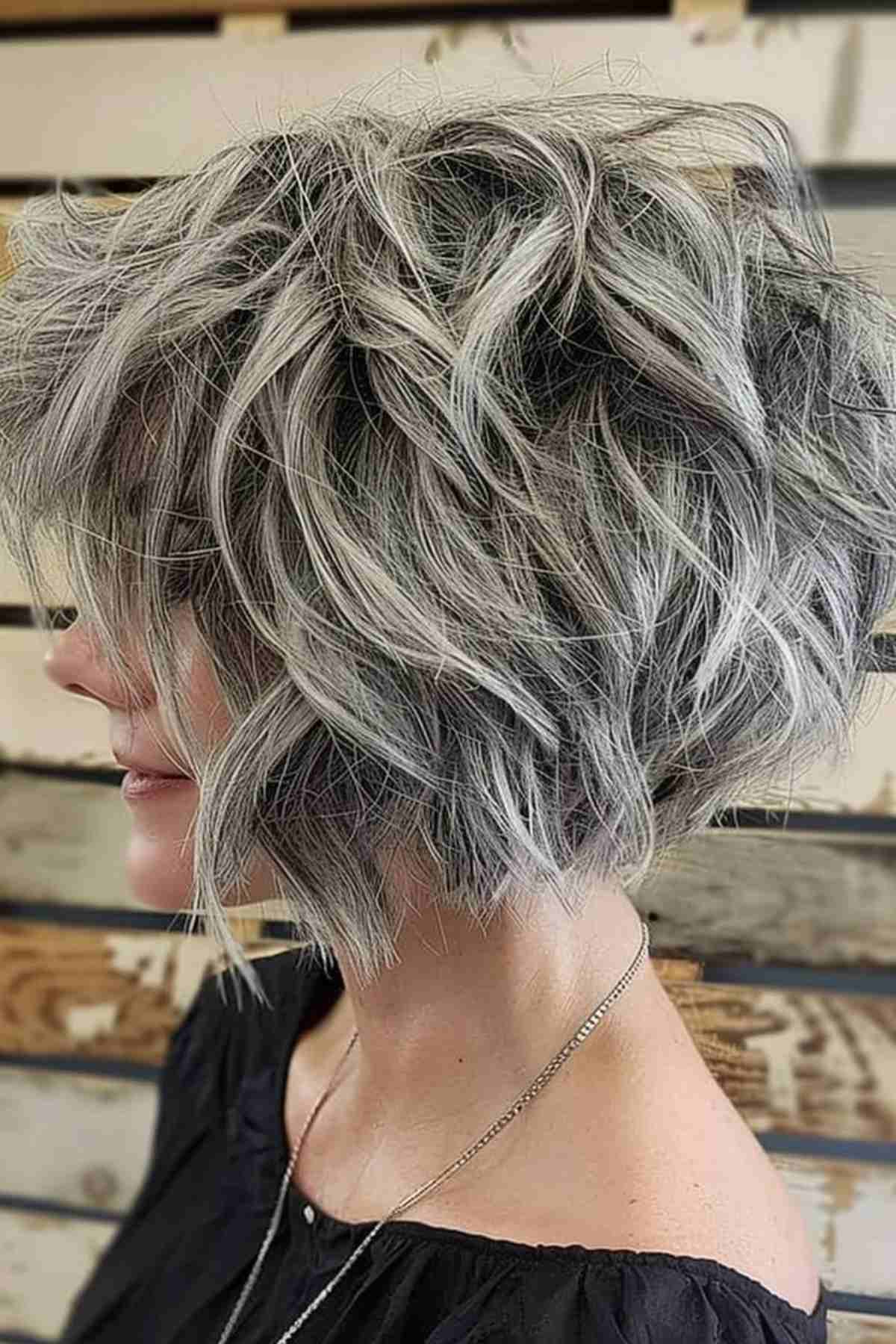 Textured tousled ash gray bob hairstyle for mature women showcasing modern styling and natural gray blending