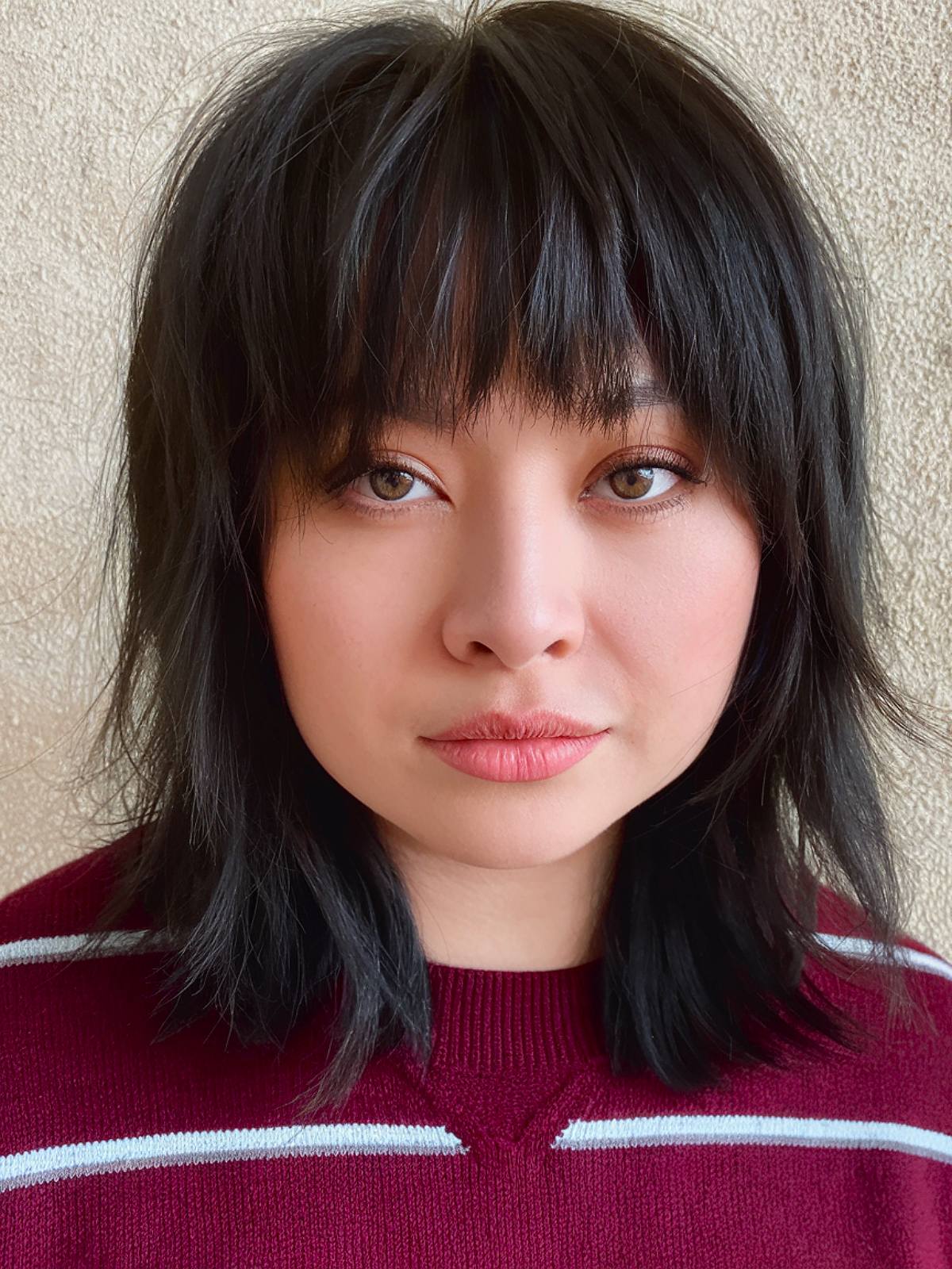 Emo-inspired shag with choppy layers and full fringe