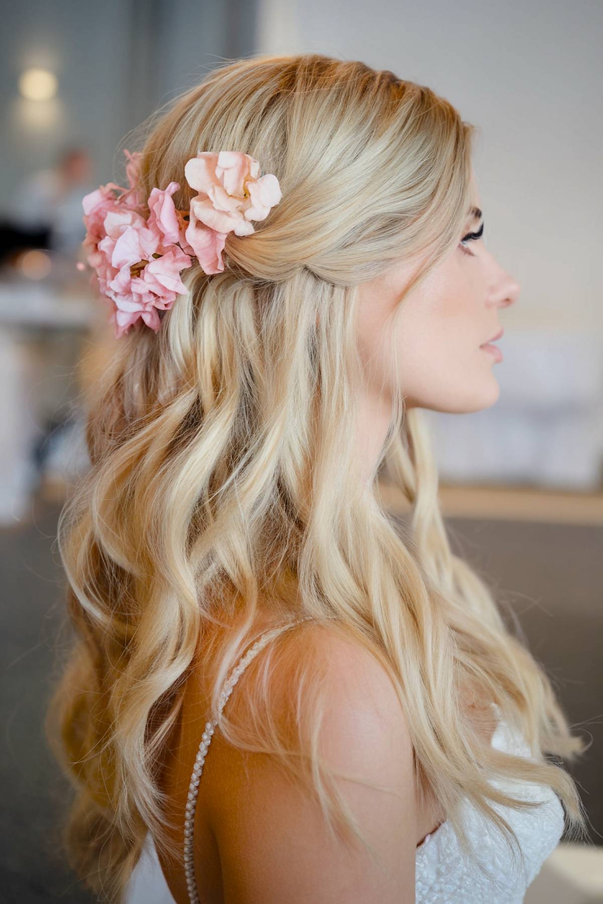 Fall-inspired wedding hairstyle with blush-pink flowers