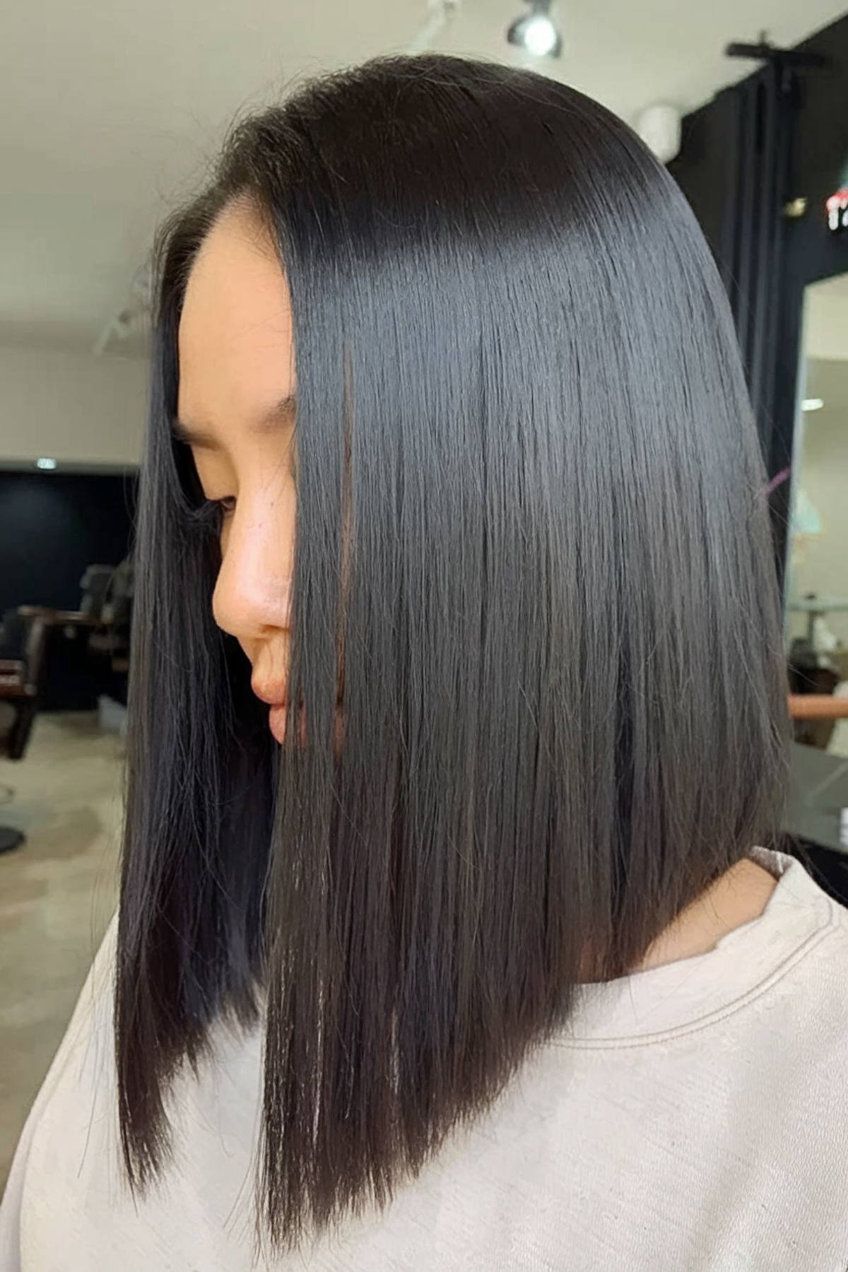 Medium-length angled bob cut with sleek finish