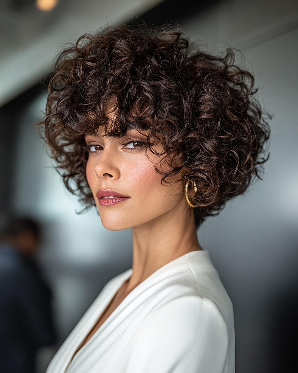 Twistelle cut with cropped curls and sculpted layered volume