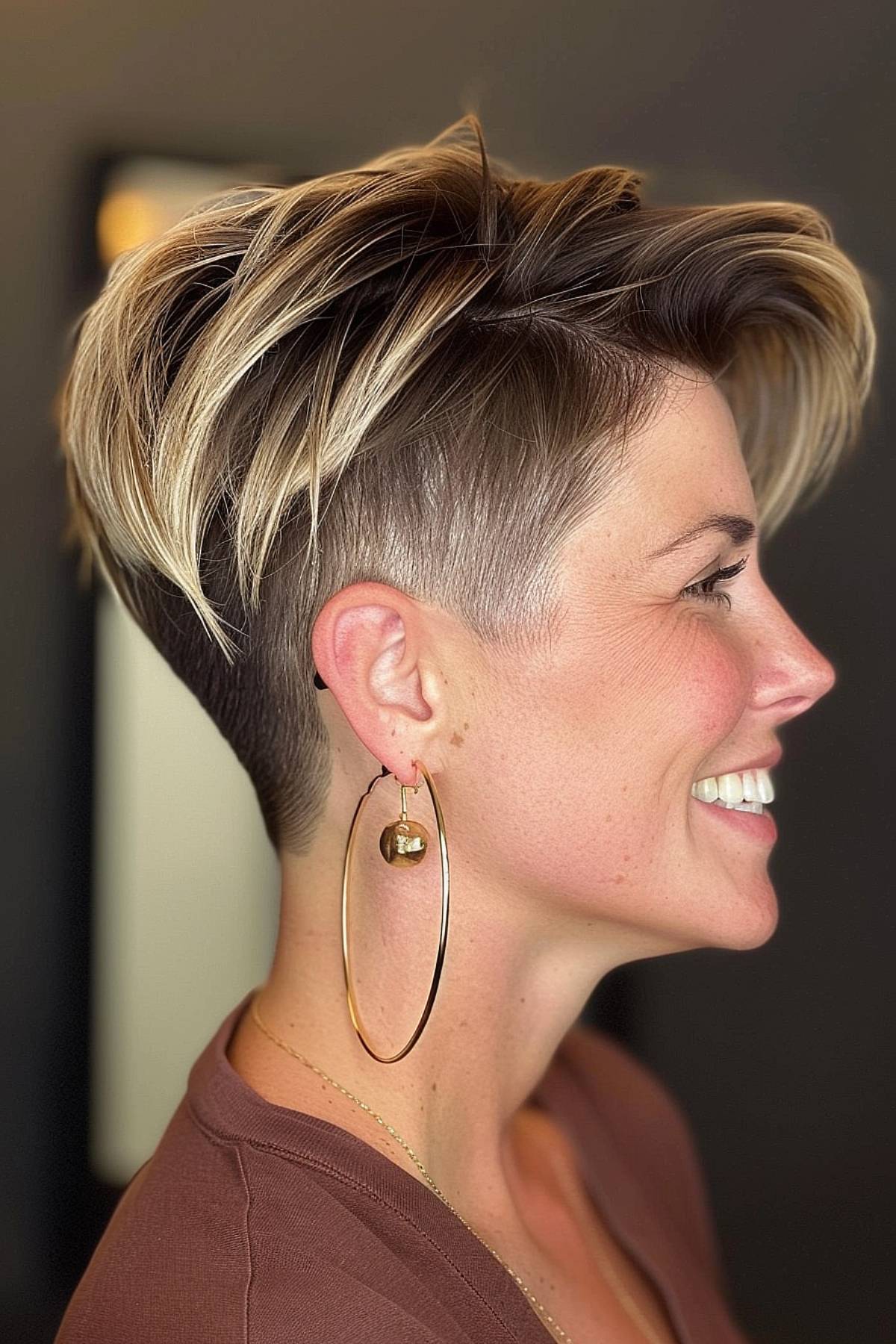 A woman with an angular pixie cut with an undercut. The textured top gives a modern and fashionable look.