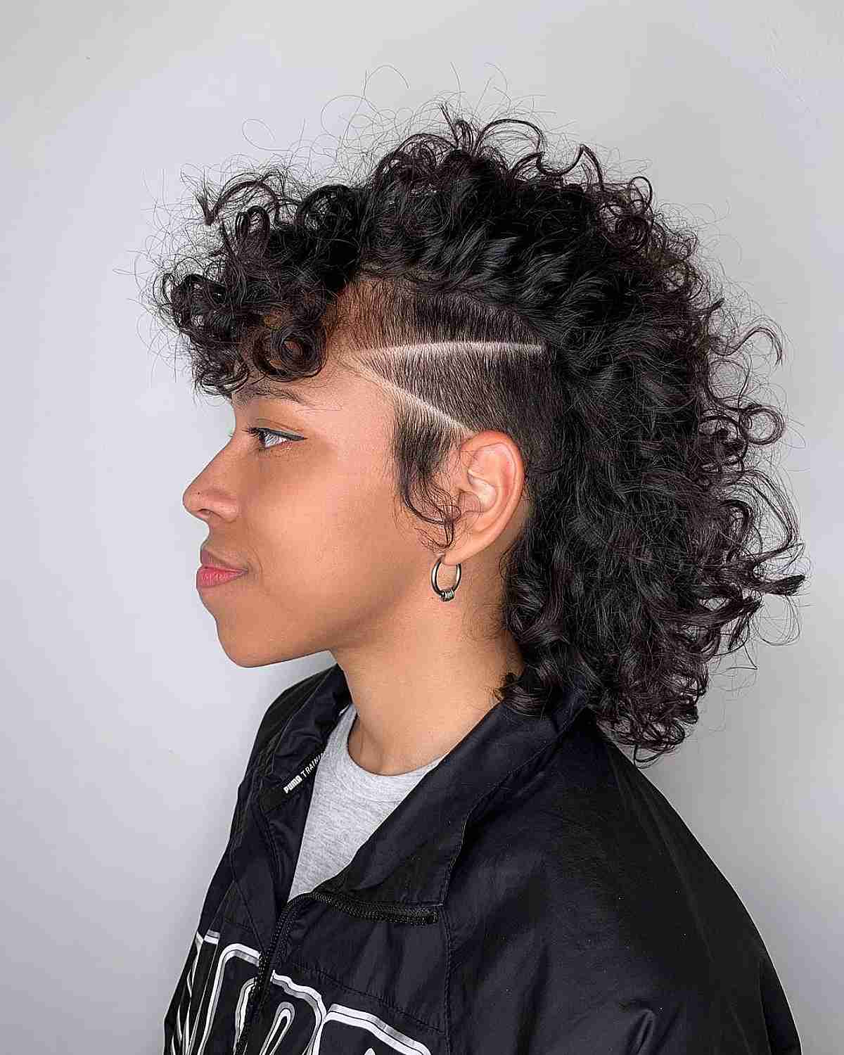 Undercut Mid-Length Curly Mohawk with Buzzed Lines