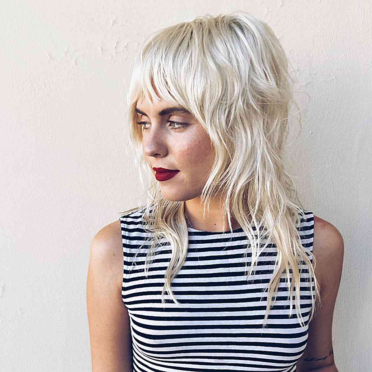 Undone Shaggy Mullet with Fringe for women with platinum hair and choppy ends