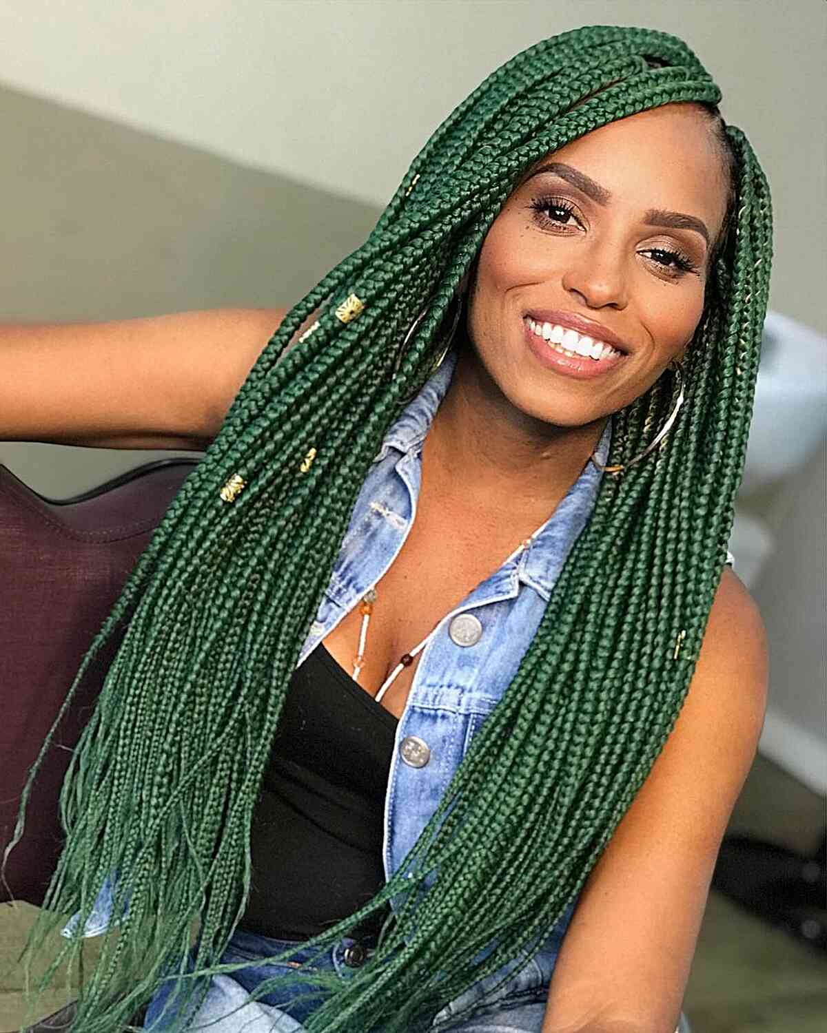 Very Long Dark Green Box Braids for black women with a slide part and gold cuffs