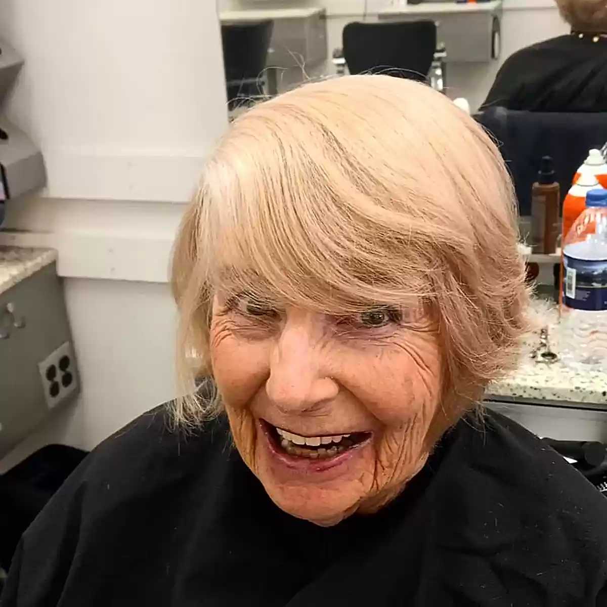 Very Short Layered Bob with Blowout and Side-Swept Bangs for Seniors over 70