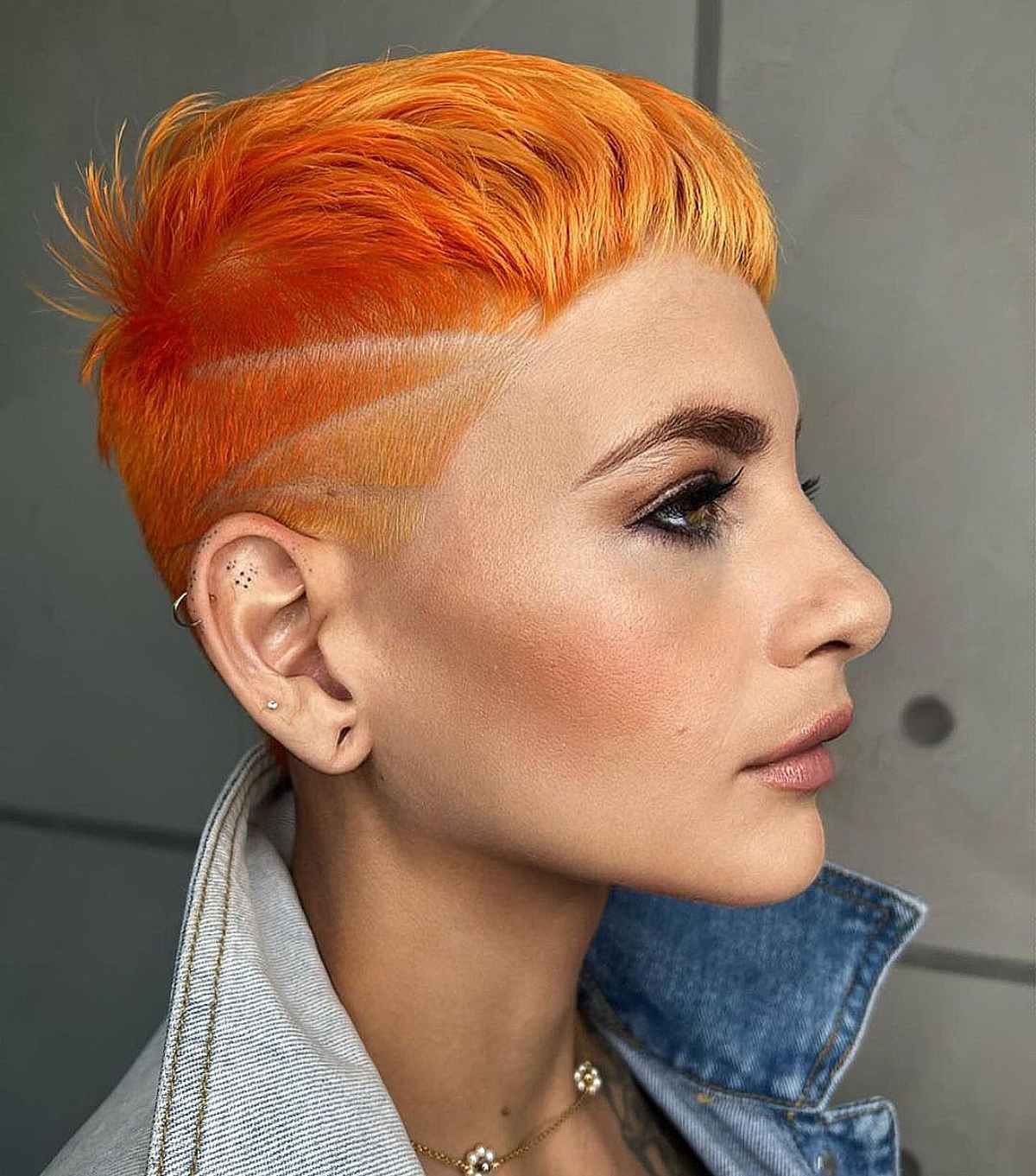 Vibrant orange pixie cut with bold shaved design on fine to medium hair