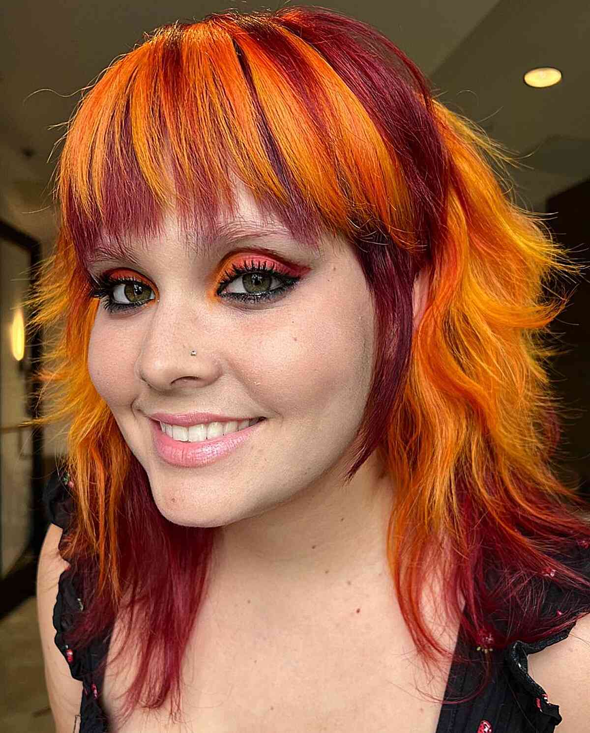Vibrant Red and Orange Tones for women with mid-length straight hair
