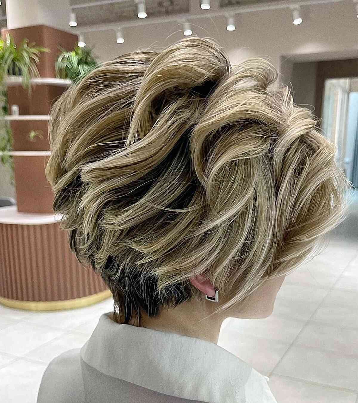Visible Layers on a Long Pixie Bob Cut with blonde highlights and dark roots