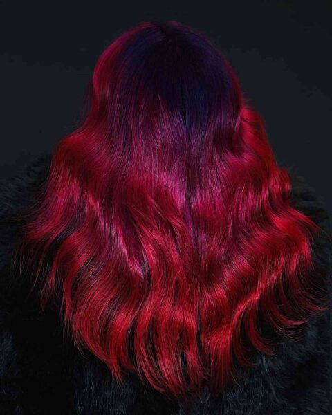 A Vivid Black Roots to Red Balayage Ombre