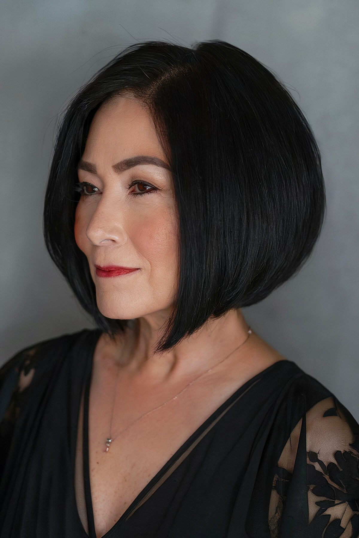 Sleek, curved bob with a dramatic angle, perfect for older women looking for a bold and refined hairstyle