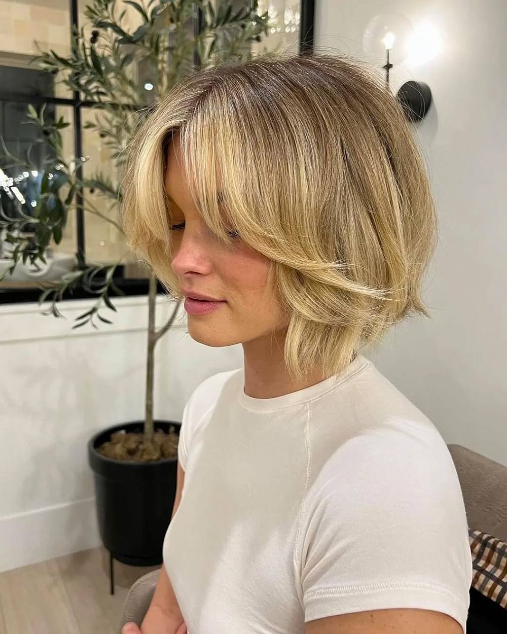 Short voluminous bob with curtain bangs and layered ends for fine to medium hair texture