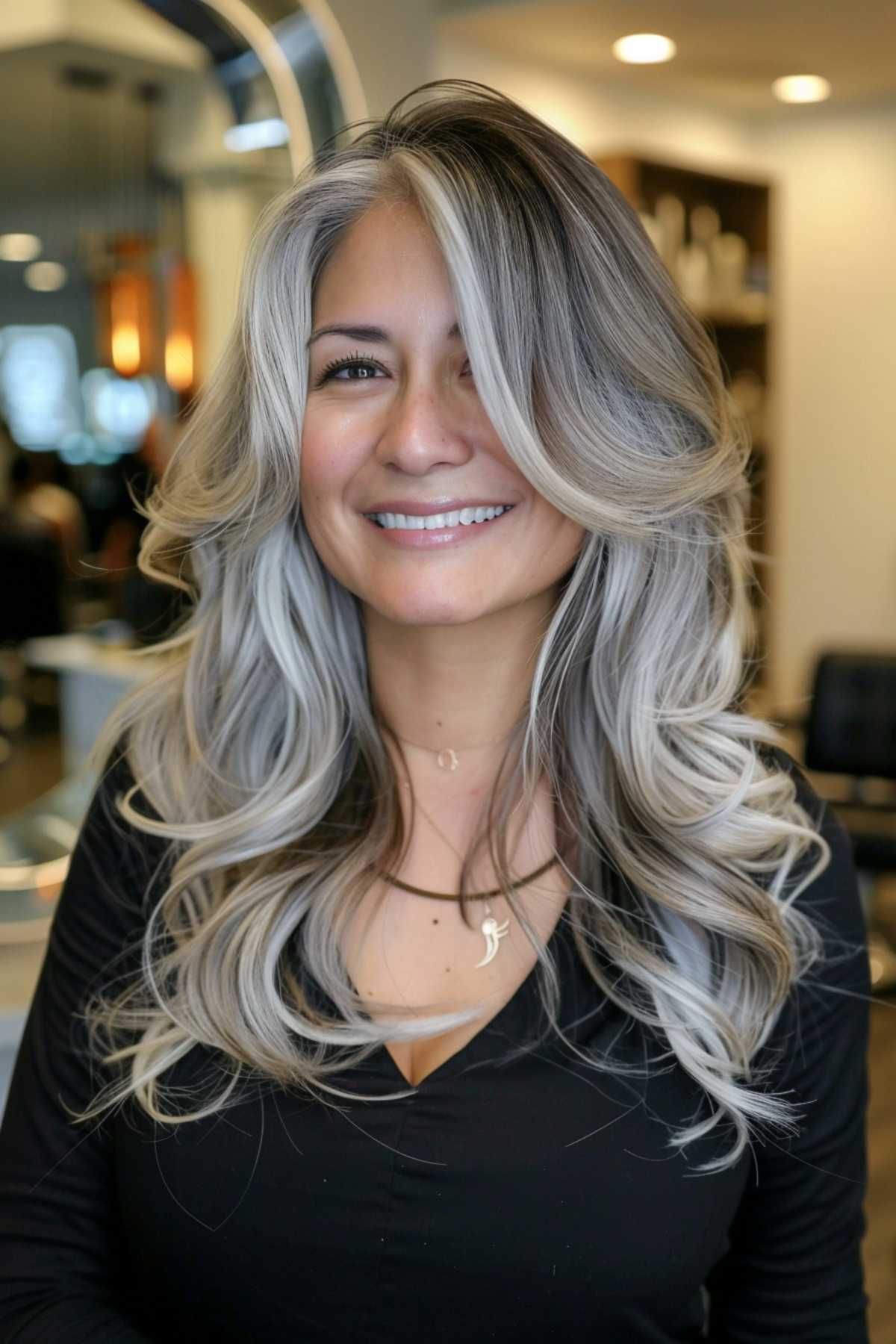 Voluminous curls with grey roots hairstyle