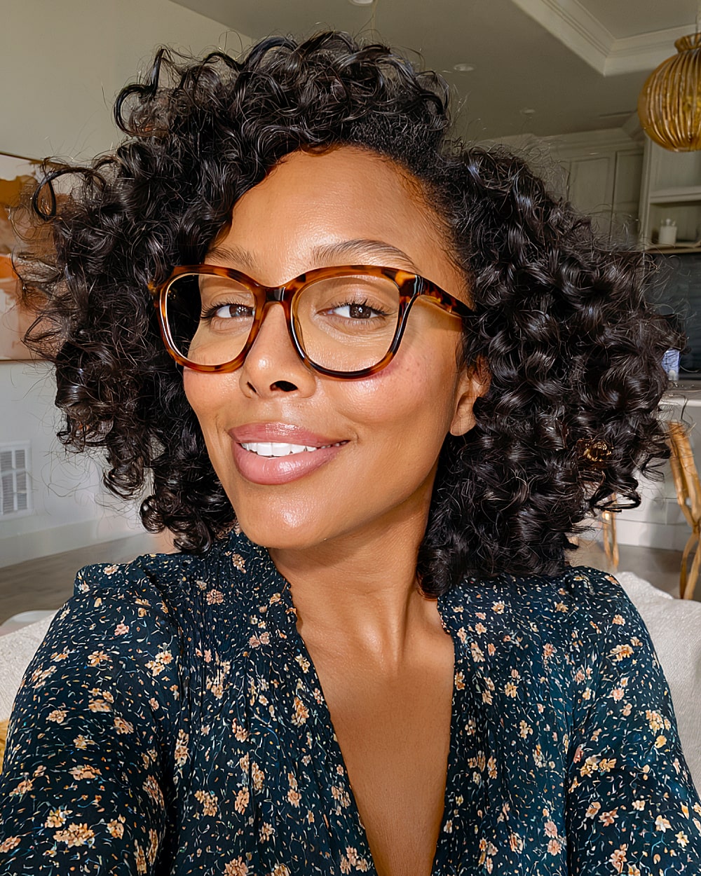 Voluminous curly bob with deep side part and springy curls