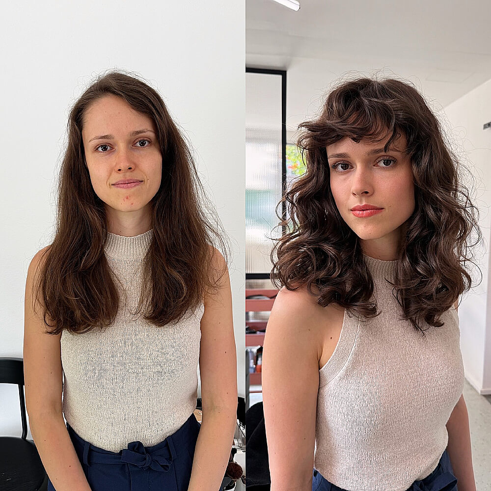 Voluminous curly shag with soft fringe for long faces, adding width and bounce to medium-length brunette hair
