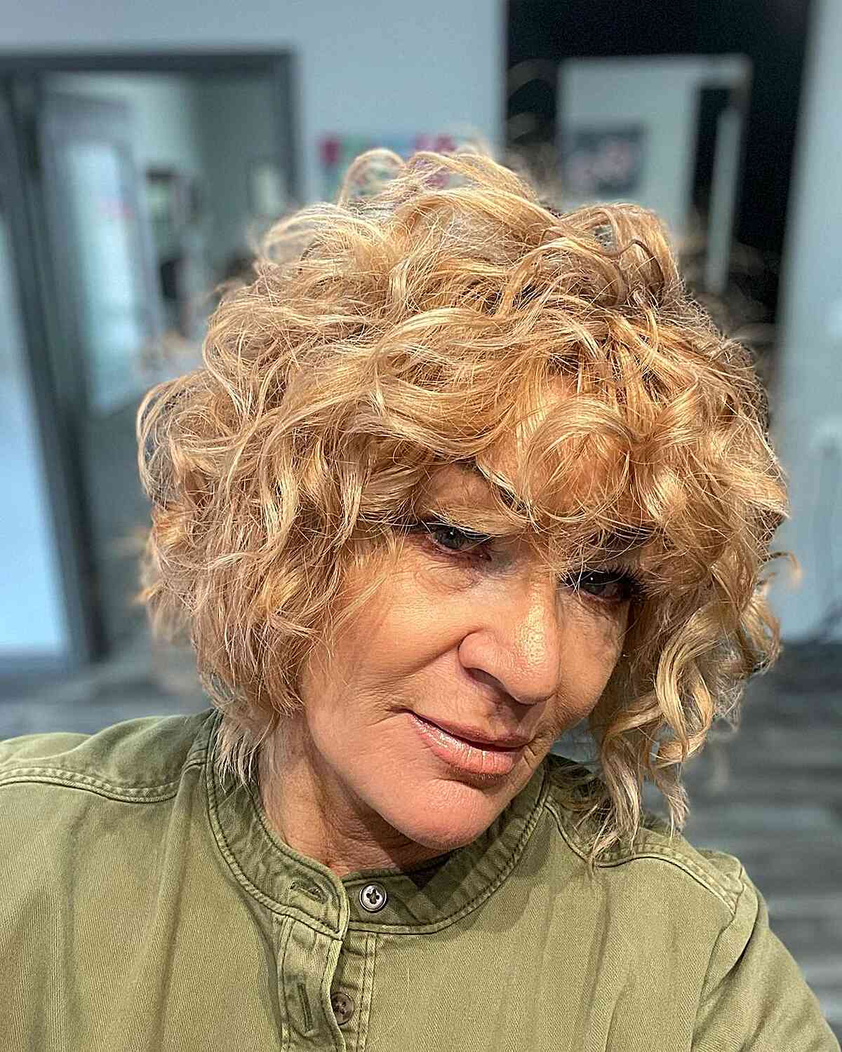 Jaw-Length Voluminous Layered Bob with Bangs and Curls of Senior Women with Blonde Hair