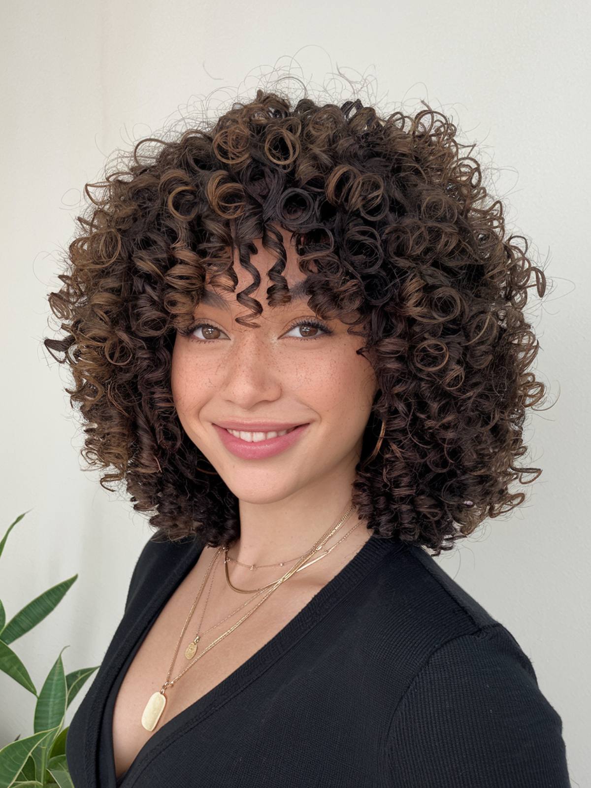 Curly layered haircut with a rounded shape for natural curls