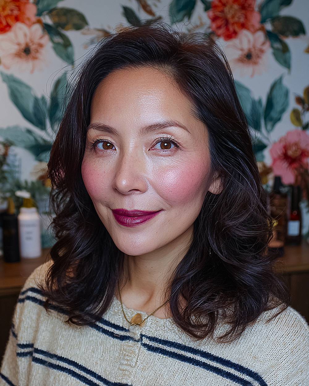 Voluminous shoulder-length waves on dark hair styled for fullness and movement, a stylish hairstyle for mature women