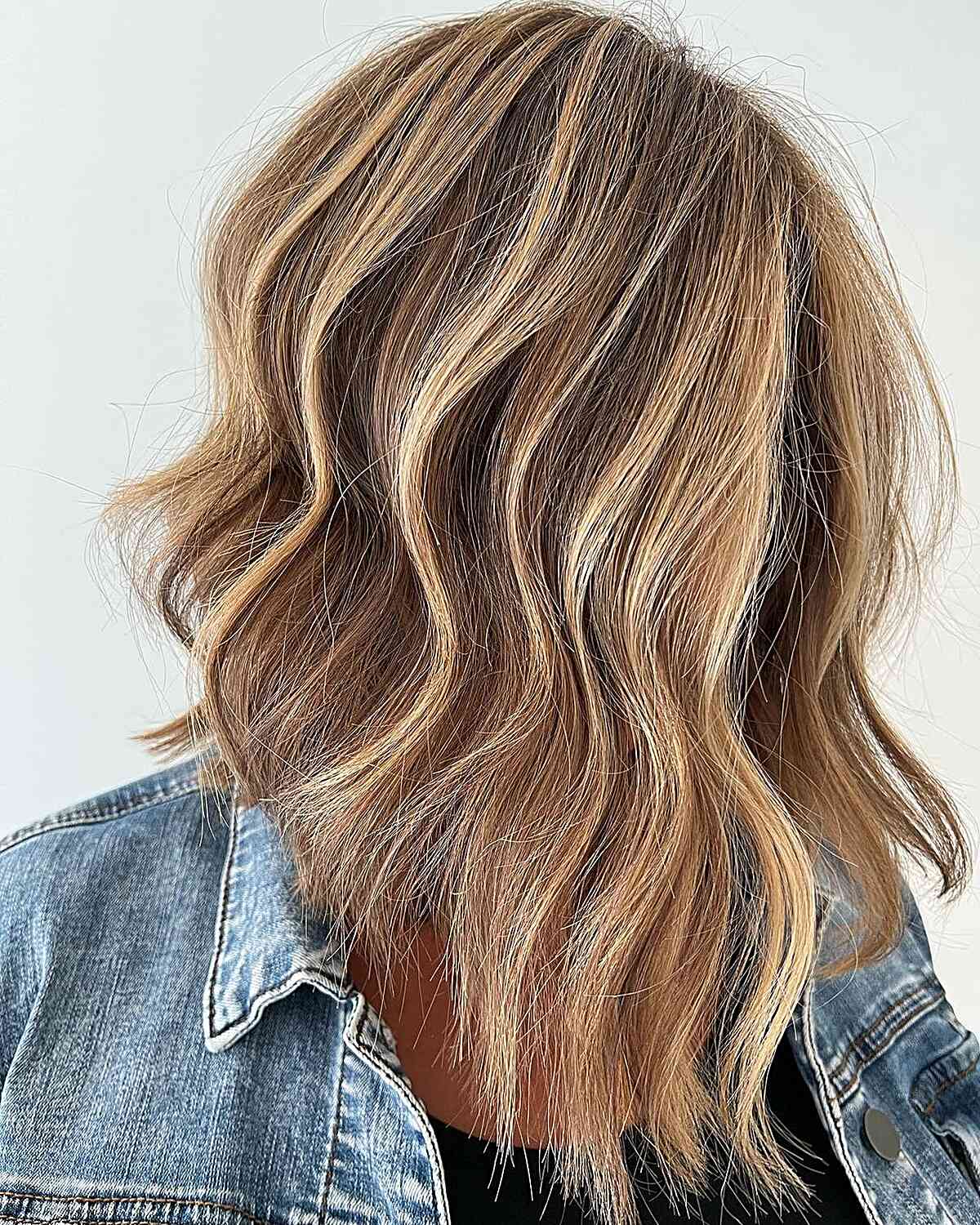 Warm Blonde Highlights on Neck-Length A-Line Brown Hair